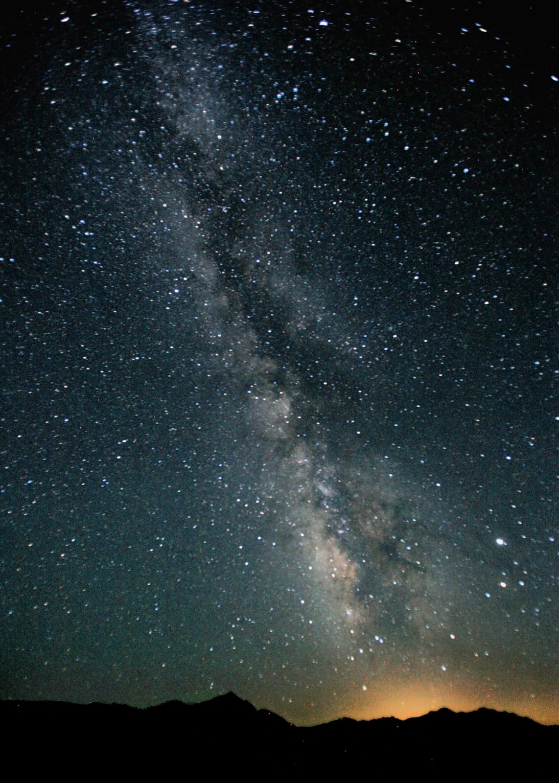 Desert camp under a star-filled night sky at Sam Sand Dunes
